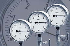 Three air compressor gauges next to each other with a gauge screen as the background image