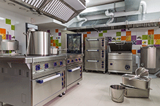 Color image of a kitchen filled with restaurant equipment
