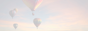 Color faded image of five hot air balloons with clouds at sunset