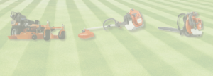 Various power equipment including a riding lawnmower, weed whacker, and leaf blower