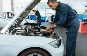 Mechanic reading a car's error codes with diagnostic device - First Western Equipment Finance