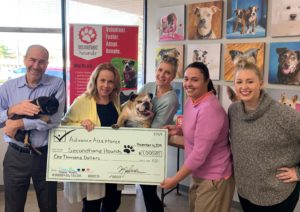 First Western Equipment Finance partners with local animal rescue - picture of team, dog, and check